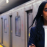 Saron Gebresellassi Mayoral Candidate for City of Toronto 2018 campaign stands powerfully in front of TTC subway on a subway platform to solidify support for transit improvements.
